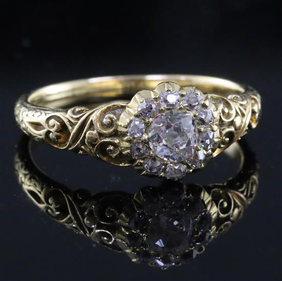 A Victorian gold and eleven stone old cut diamond cluster ring, size P/Q.
